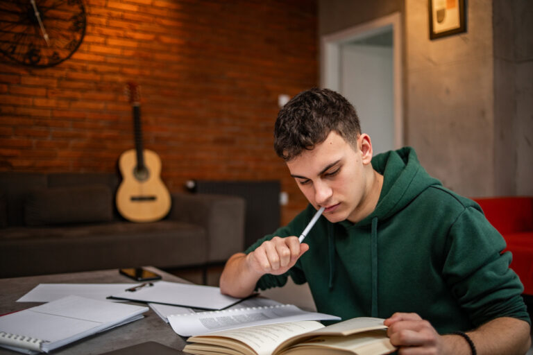 Young man concentrating while trying to study