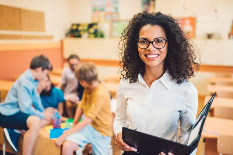 Portrait of mixed race teacher in class looking at camera