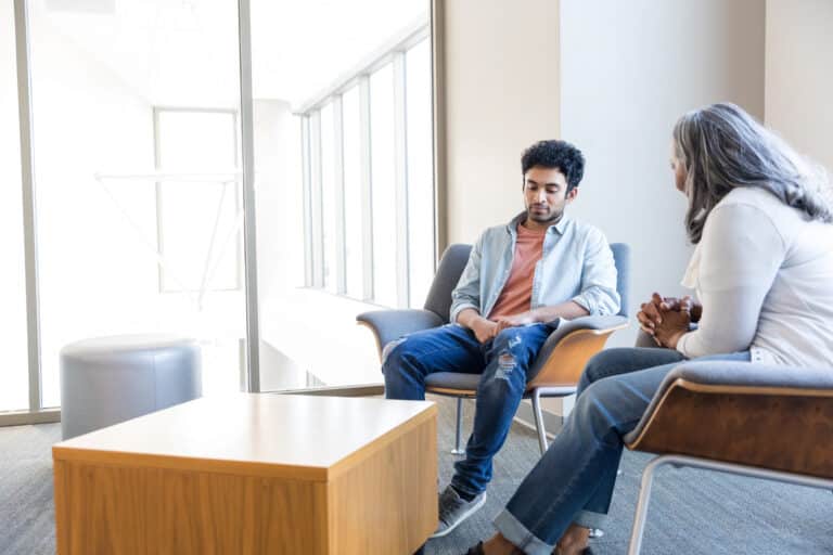 Counsellor explaining the 7 stages of trauma bonding to a client