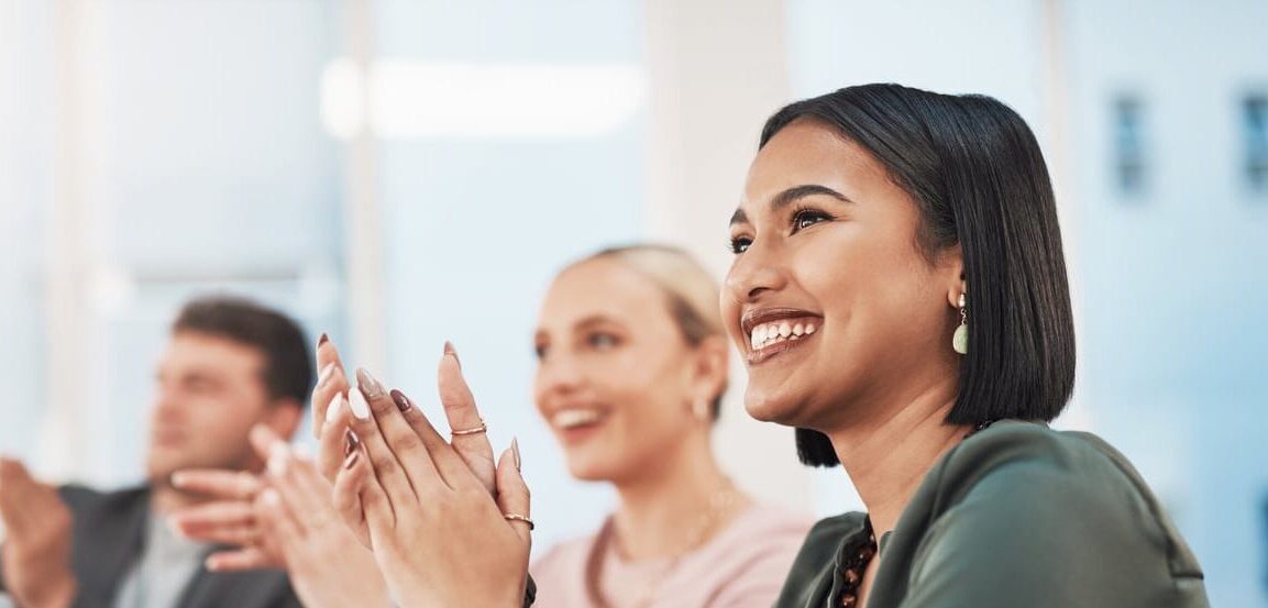 Group of employees celebrating the internal promotion of their colleague