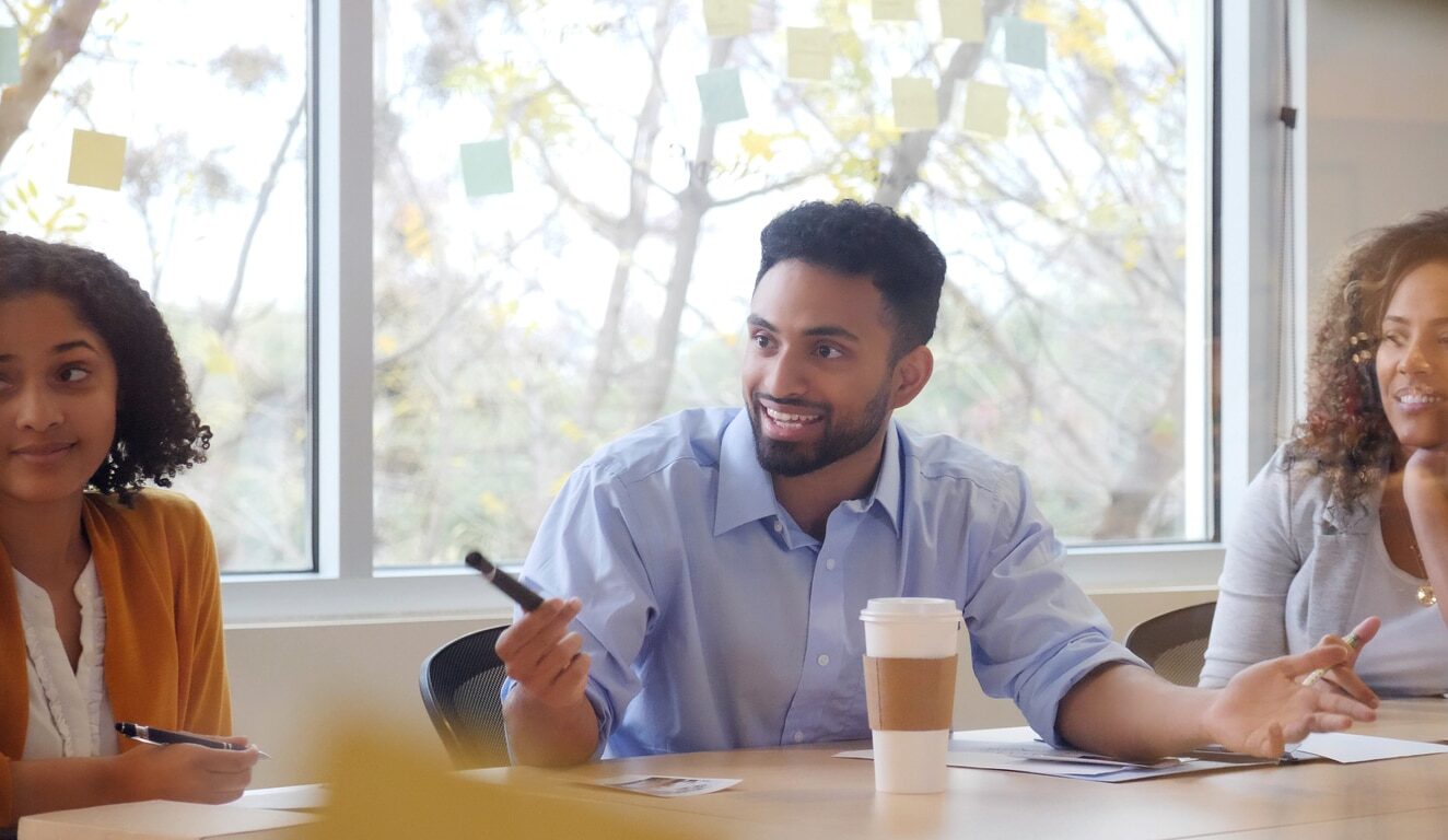 Young business man using persuasion when presenting a new idea to his colleagues