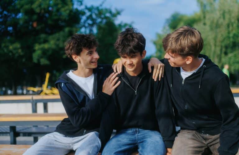 Group o teen boys using positive peer pressure to motivate one another